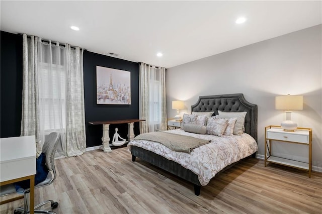 bedroom with visible vents, recessed lighting, baseboards, and wood finished floors