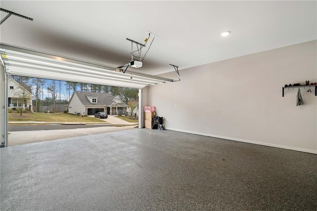 garage featuring a garage door opener and baseboards