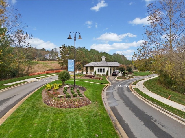 view of road featuring curbs, street lights, and sidewalks