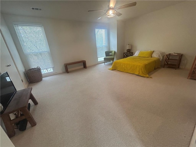 unfurnished bedroom featuring visible vents, carpet flooring, and a ceiling fan