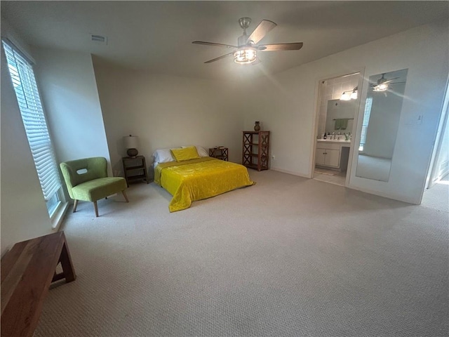 unfurnished bedroom featuring visible vents, carpet, ceiling fan, and ensuite bathroom