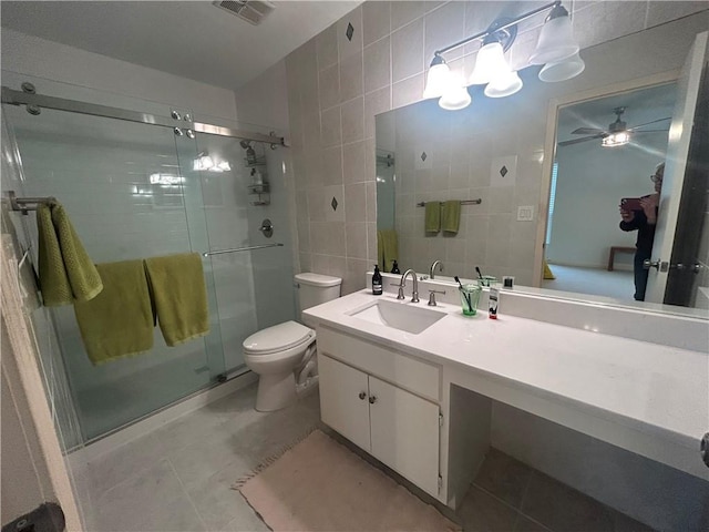 bathroom with tile walls, visible vents, a stall shower, and tile patterned floors