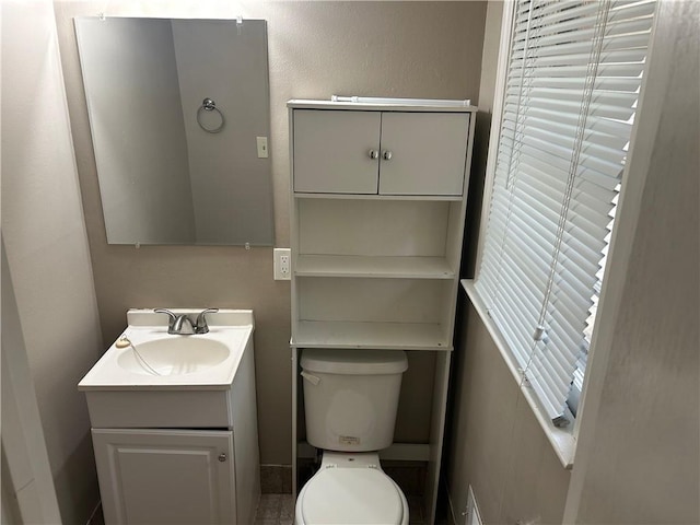 half bathroom with vanity and toilet