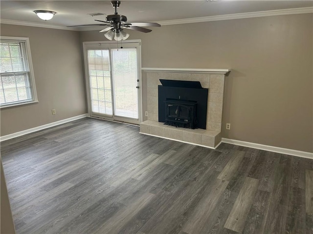 unfurnished living room featuring wood finished floors, a ceiling fan, visible vents, baseboards, and crown molding