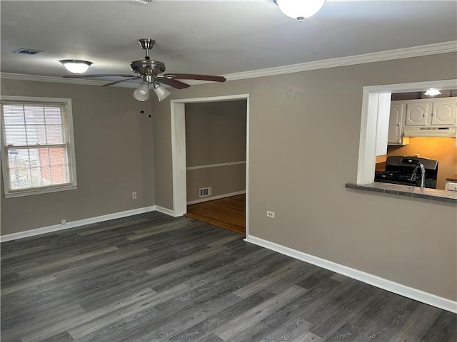 unfurnished room featuring crown molding, a ceiling fan, and visible vents