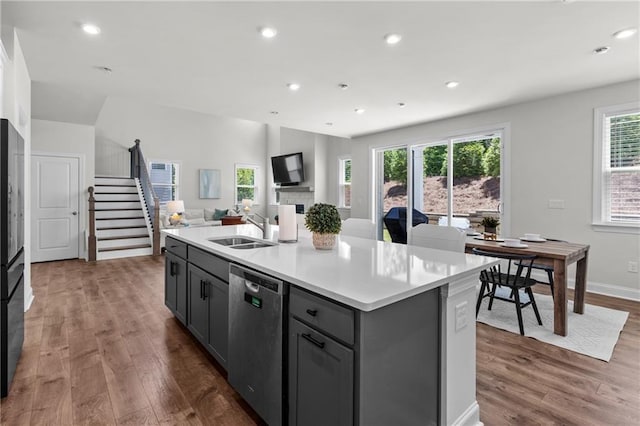 4011 Fallen Leaf Ct, Kennesaw, GA 30152 - kitchen featuring stainless steel dishwasher, a sink, dark wood-type flooring, gray cabinetry, and light countertops
