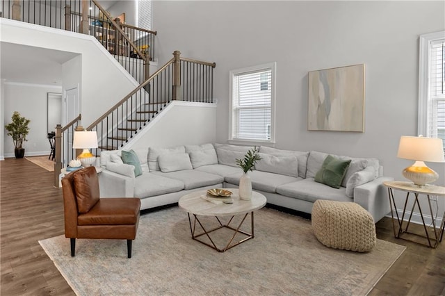 4011 Fallen Leaf Ct, Kennesaw, GA 30152 - living area with a towering ceiling, wood finished floors, stairway, and baseboards