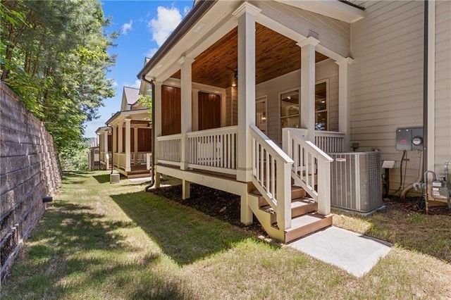 view of side of home featuring cooling unit, a deck, and a lawn