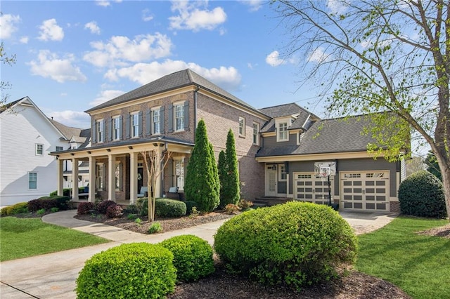 673 Dunbrody Dr, Milton, GA 30004 - view of front of property featuring a front lawn, brick siding, a garage, and covered porch