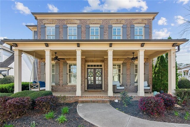 673 Dunbrody Dr, Milton, GA 30004 - doorway to property featuring brick siding, covered porch, french doors, and a ceiling fan