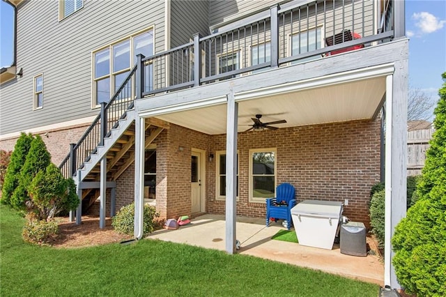 673 Dunbrody Dr, Milton, GA 30004 - back of house featuring ceiling fan, brick siding, a lawn, a patio area, and stairs