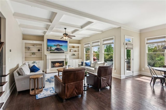673 Dunbrody Dr, Milton, GA 30004 - living room with healthy amount of natural light, a lit fireplace, a ceiling fan, dark wood-style floors, and beamed ceiling