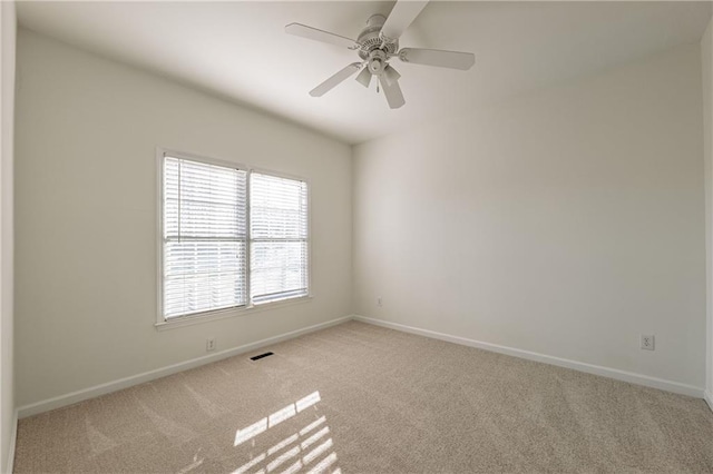 unfurnished room with baseboards and light carpet