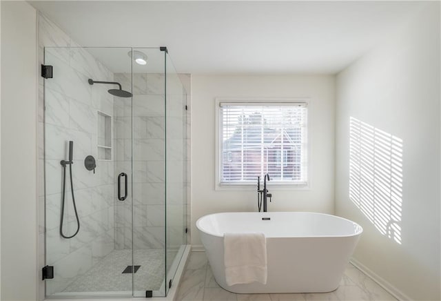 full bath with a shower stall, baseboards, marble finish floor, and a freestanding bath