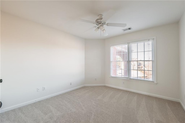 spare room with visible vents, baseboards, carpet floors, and ceiling fan