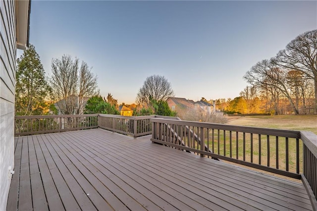 wooden terrace featuring a lawn