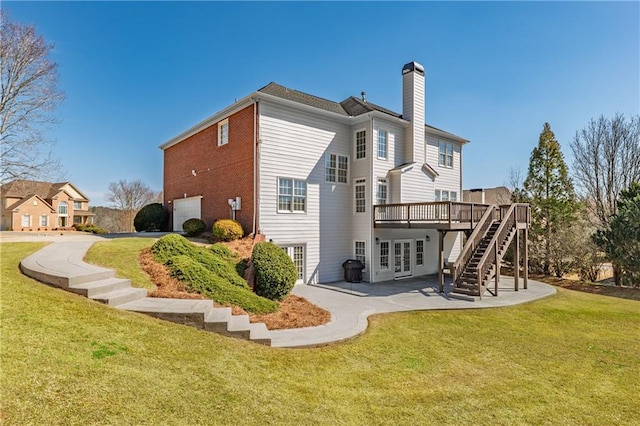 rear view of house featuring a patio, a lawn, a deck, and a chimney