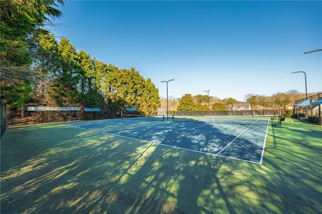 view of sport court featuring fence