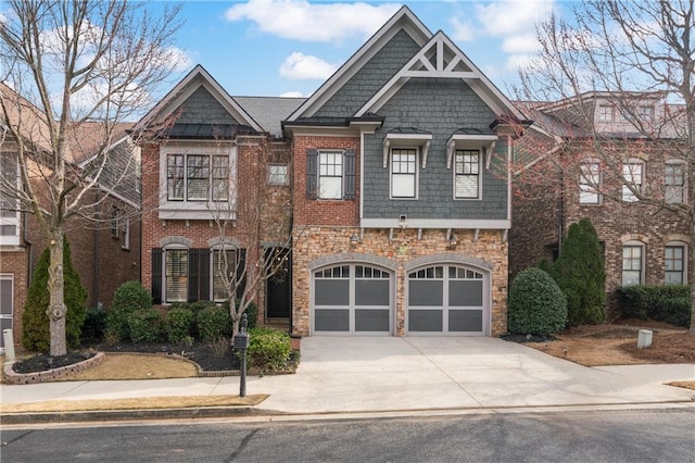 view of front of house with stone siding, brick siding, driveway, and an attached garage