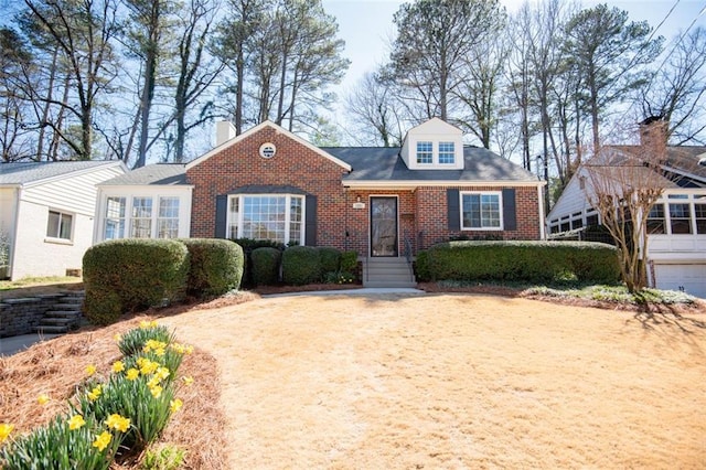 new england style home featuring brick siding