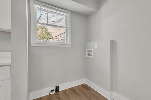 laundry area featuring laundry area, hookup for a washing machine, baseboards, and wood finished floors