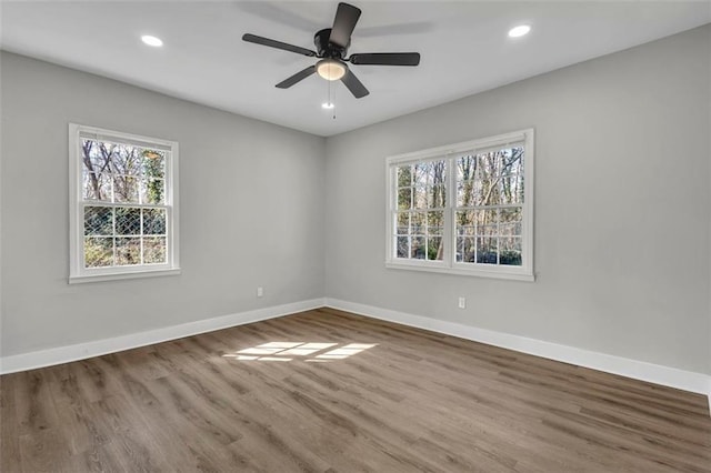 unfurnished room featuring plenty of natural light, baseboards, and recessed lighting