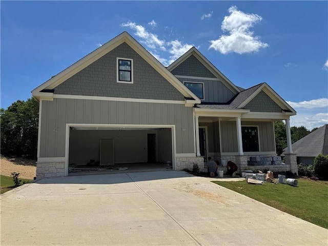 3 Outpost Trl SE, Rome, GA 30161 - craftsman-style home with stone siding, concrete driveway, board and batten siding, and covered porch