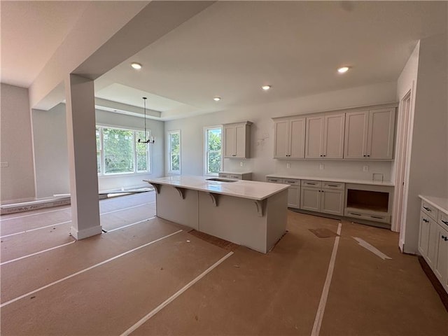 3 Outpost Trl SE, Rome, GA 30161 - kitchen with recessed lighting, decorative light fixtures, a center island, a breakfast bar area, and concrete floors