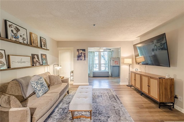 215 Cobblestone Trl, Avondale Estates, GA 30002 - living area with a textured ceiling, wood finished floors, baseboards, and a ceiling fan