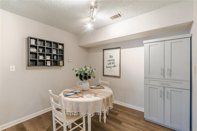215 Cobblestone Trl, Avondale Estates, GA 30002 - dining space with wood finished floors, a textured ceiling, baseboards, and track lighting