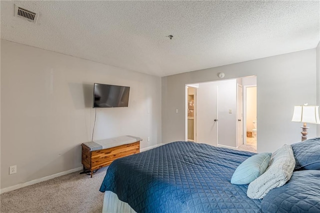 215 Cobblestone Trl, Avondale Estates, GA 30002 - bedroom featuring carpet floors, baseboards, a textured ceiling, and ensuite bath