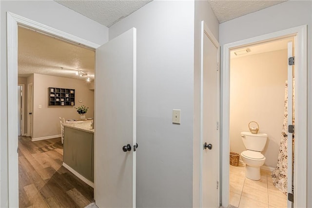 215 Cobblestone Trl, Avondale Estates, GA 30002 - corridor with a textured ceiling and wood finished floors