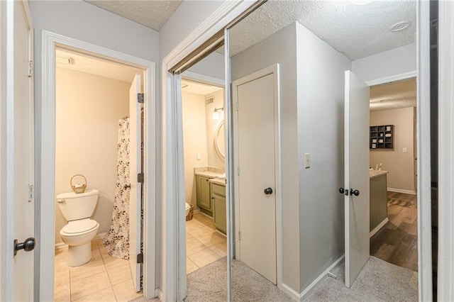 215 Cobblestone Trl, Avondale Estates, GA 30002 - hallway featuring a textured ceiling and light tile patterned floors