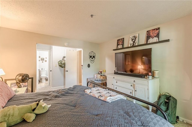 215 Cobblestone Trl, Avondale Estates, GA 30002 - bedroom featuring carpet flooring, baseboards, a textured ceiling, and ensuite bath