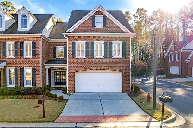 view of front of property with a front yard and a garage