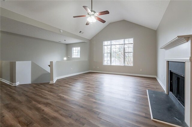 unfurnished living room with lofted ceiling, ceiling fan, and dark hardwood / wood-style floors