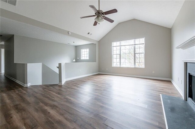 unfurnished living room featuring dark hardwood / wood-style floors, vaulted ceiling, and ceiling fan