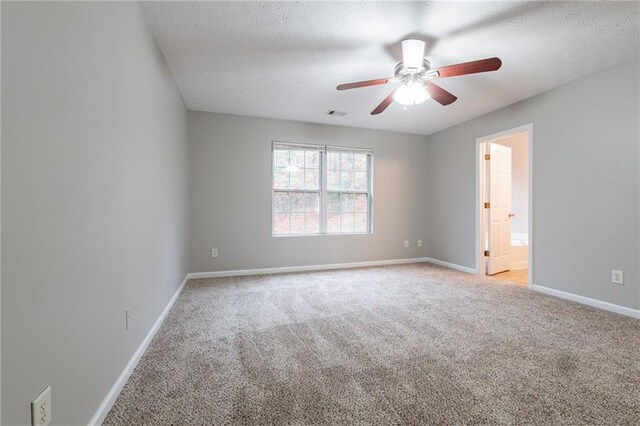 unfurnished room with light carpet, a textured ceiling, and ceiling fan