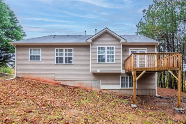 back of property with a wooden deck