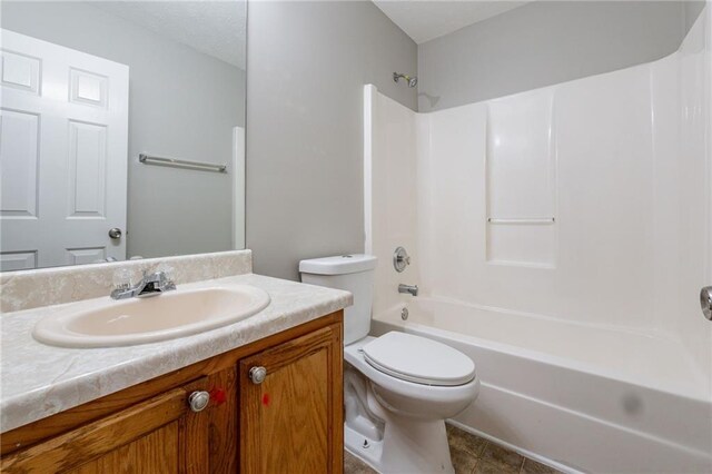 full bathroom with tile patterned floors, vanity, bathing tub / shower combination, and toilet