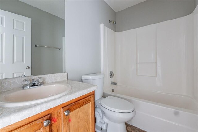 full bathroom with tile patterned floors, shower / washtub combination, vanity, and toilet