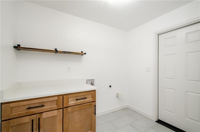 washroom featuring hookup for an electric dryer, light tile patterned floors, and hookup for a washing machine