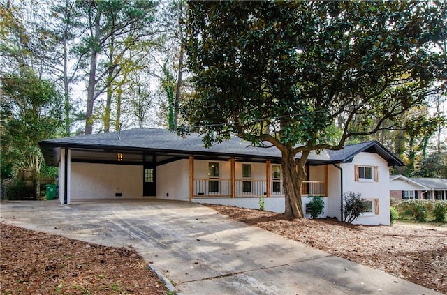 view of front facade with a porch and a carport