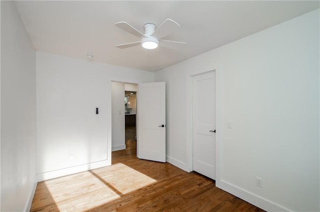 unfurnished bedroom with ceiling fan and hardwood / wood-style floors