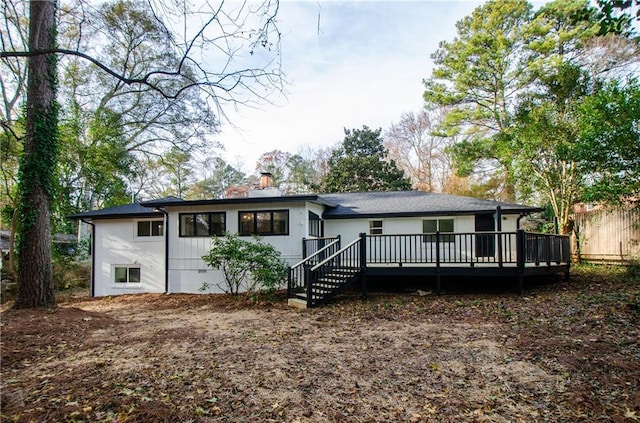 rear view of property featuring a deck