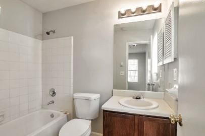 full bathroom featuring vanity, toilet, and tiled shower / bath