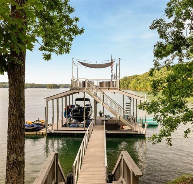dock area with boat lift, stairway, and a water view