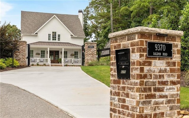 exterior space with concrete driveway and covered porch