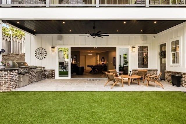 exterior space with an outdoor kitchen, a patio area, a balcony, and ceiling fan