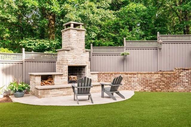view of patio with fence and an outdoor stone fireplace